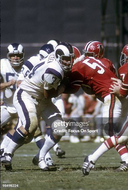 S: Defensive Tackle Merlin Olsen of the Los Angeles Rams is blocked by guard Dennis Havig of the Atlanta Falcons circa early 1970's during an NFL...