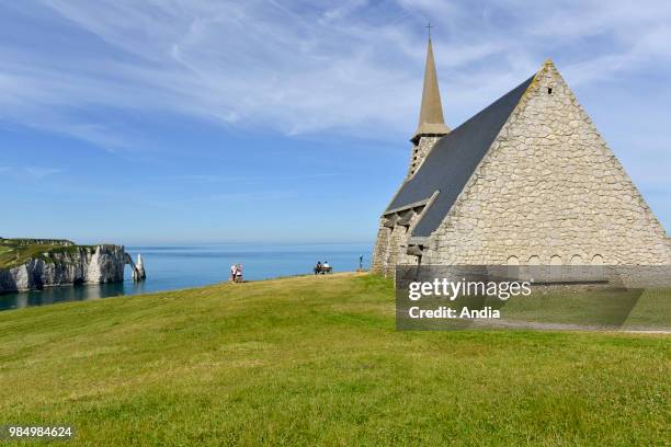 Etretat , town along the 'Cote d'Albatre' , in the area called 'pays de Caux'. Chapel of Notre-Dame-de-la-Garde. In the background, the arch 'Porte...