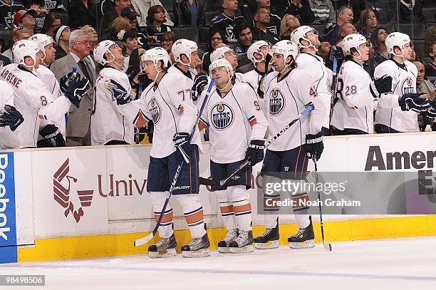 Tom Gilbert, Mike Comrie and Zack Stortini of the Edmonton Oilers celebrate with the bench after a goal against the Los Angeles Kings on April 10,...