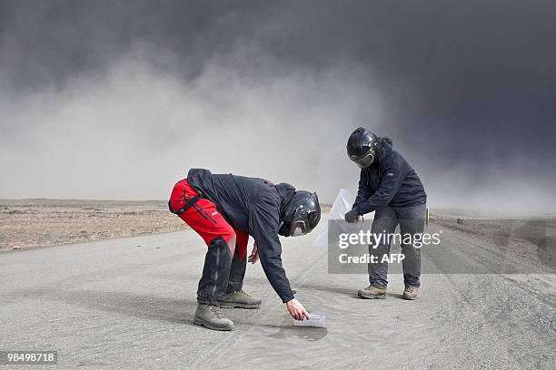 Volcanic scientists collect samples of ash to send to labs to analyze its content, in eastern Iceland on April 15, 2010. A cloud of ash from the...