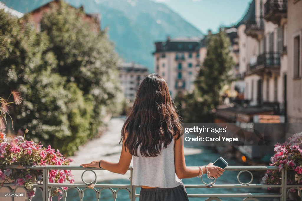 Rear view of woman in Chamonix-Mont Blanc village and French alps