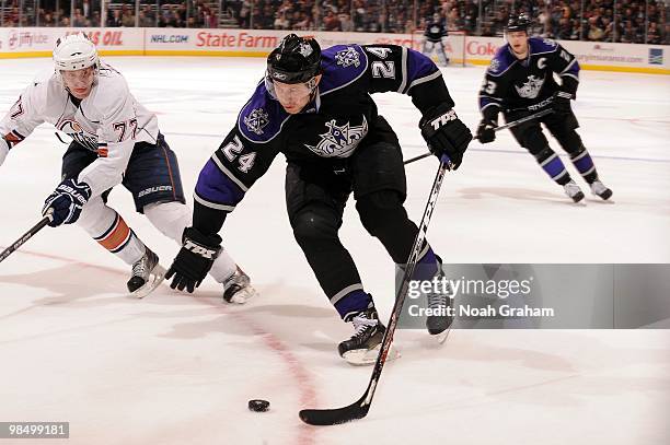 Alexander Frolov of the Los Angeles Kings skates with the puck against Tom Gilbert of the Edmonton Oilers on April 10, 2010 at Staples Center in Los...