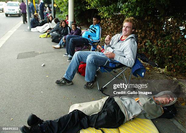 Tim Hudson and Dushan Gocec form part of a long queue of people waiting to buy tickets at a 2010 FIFA World Cup ticket sales office on April 15, 2010...