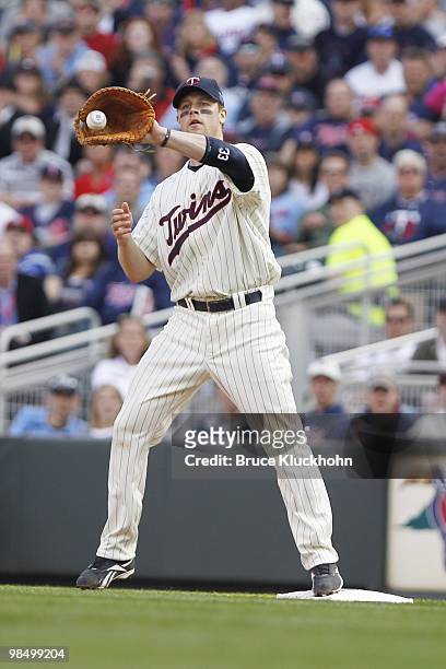 April 12: Justin Morneau of the Minnesota Twins catches a throw to put out a member of the Boston Red Sox on April 12, 2010 at Target Field in...