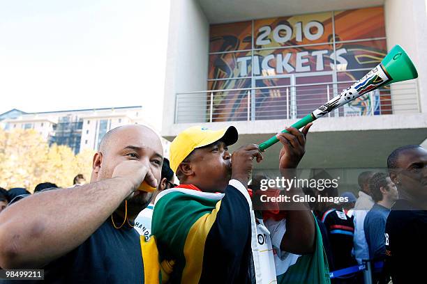 Excited fans blow vuvuzelas as they wait to buy tickets at a 2010 FIFA World Cup ticket sales office on April 15, 2010 in Sandton, South Africa. Some...