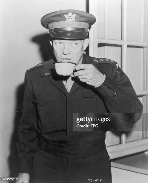 Commanding General of U.S. Army Europe, Dwight D. Eisenhower drinks a cup of coffee at Allied Headquarters in Paris, in a scene from the World War II...