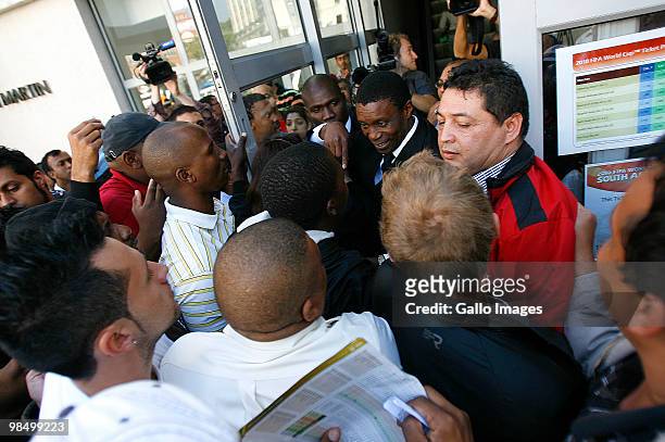 Security guards attempt to calm a crowd outside a 2010 FIFA World Cup ticket sales office on April 15, 2010 in Sandton, South Africa. Some fans...