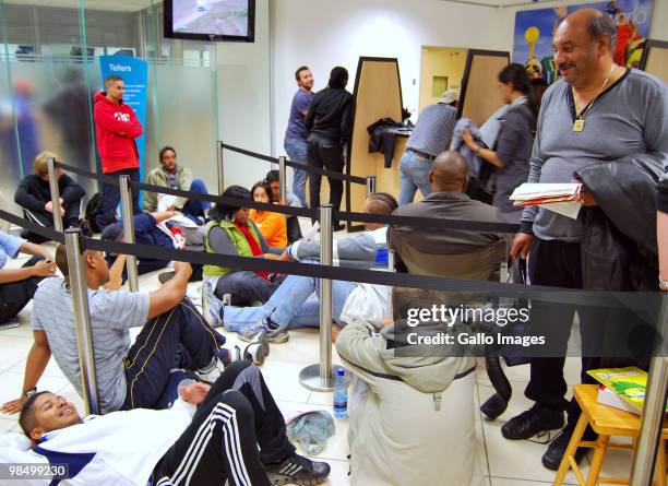 People queue for 2010 FIFA World Cup tickets inside a First National Bank on April 15, 2010 in Stellenbosch, South Africa. Some fans queued overnight...