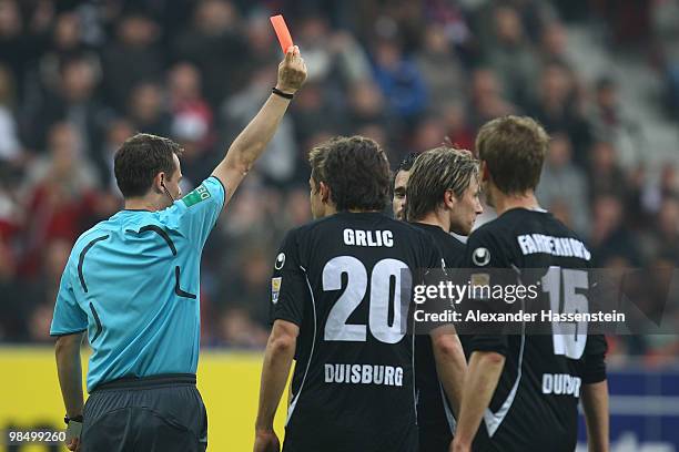 Referee Markus Schmidt shows Kristoffer Andersen of Duisburg the red card during the Second Bundesliga match between FC Augsburg and MSV Duisburg at...