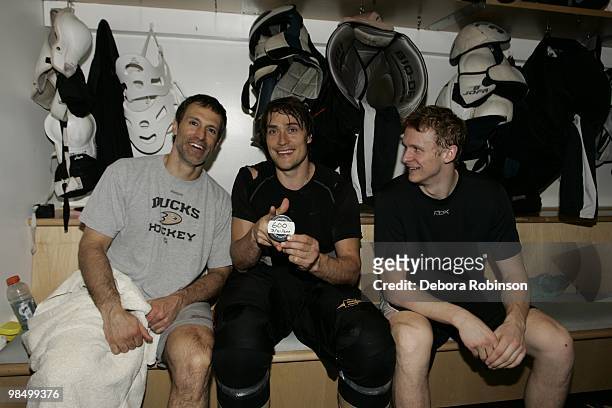 Teemu Selanne of the Anaheim Ducks poses with the puck and teammates who assisted his 600th career goal, Scott Niedermayer and Corey Perry that he...