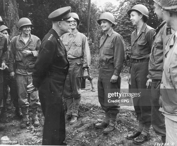 Commanding General of U.S. Army Europe, Dwight D. Eisenhower talking to a group of American soldiers about their living conditions, France, 26th July...