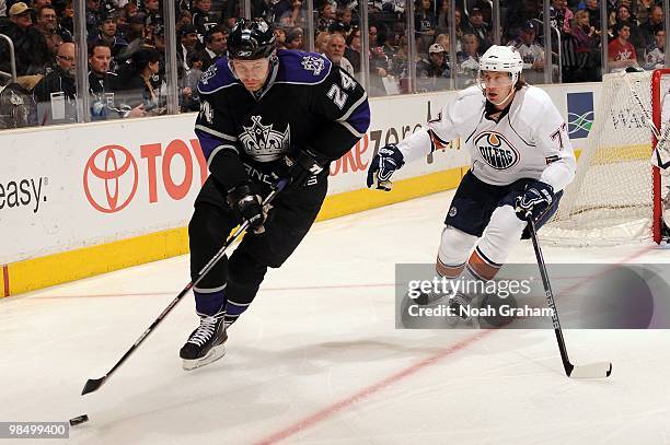 Alexander Frolov of the Los Angeles Kings skates with the puck against Tom Gilbert of the Edmonton Oilers on April 10, 2010 at Staples Center in Los...