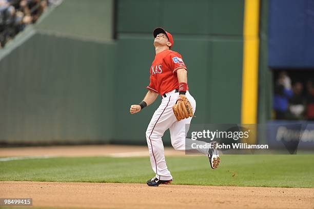 Third baseman Michael Young of the Texas Rangers fields his position as he reacts to and runs to catch a fly ball during the game against the Toronto...