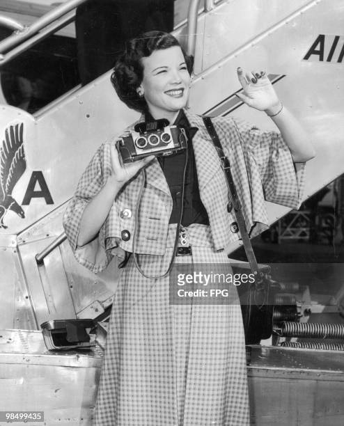 American actress and singer Nanette Fabray at La Guardia Airport, New York, circa 1950. She is holding a Stereo Realist 3-D camera.