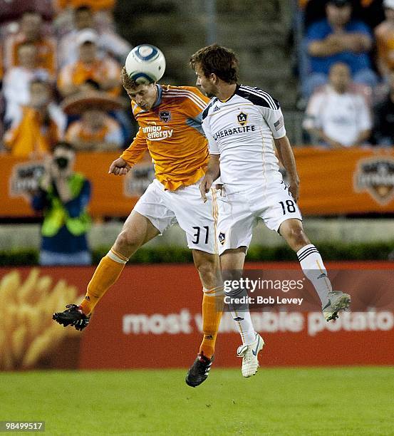 Andrew Hainult of the Houston Dynamo goes up for a header with Mike Magee of the L.A. Galaxy on April 10, 2010 in Houston, Texas.