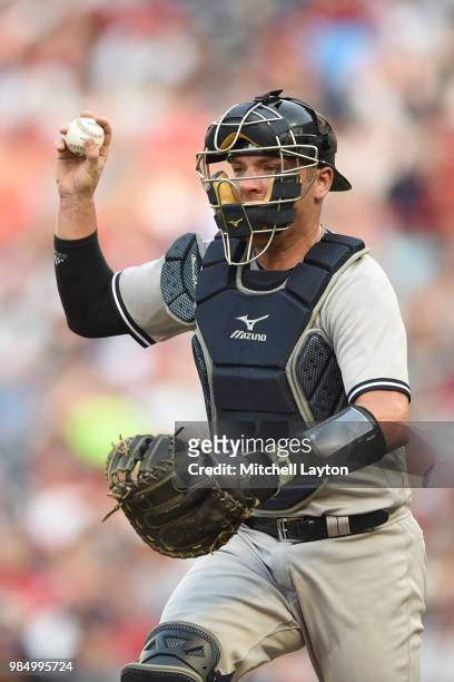 Austin Romine of the New York Yankees runs down a base runner during game two of a doubleheader against the Baltimore Orioles at Nationals Park on...