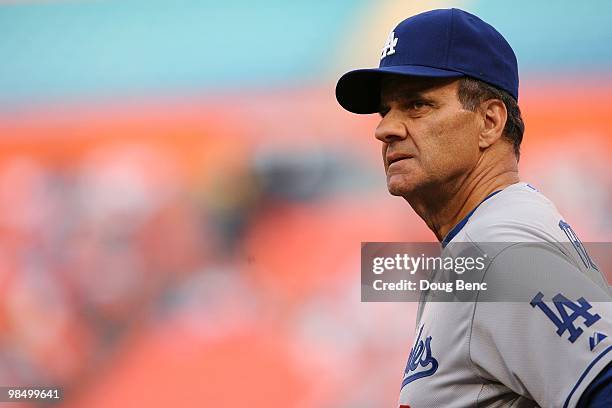 Manager Joe Torre of the Los Angeles Dodgers looks around from the field before taking on the Florida Marlins during the Marlins home opening game at...