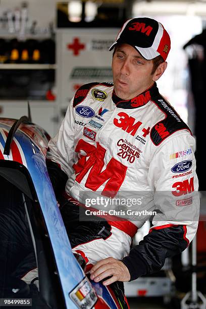 Greg Biffle, driver of the 3M Post-it Ford, climmbs into his car during practice for the NASCAR Sprint Cup Series Samsung Mobile 500 at Texas Motor...