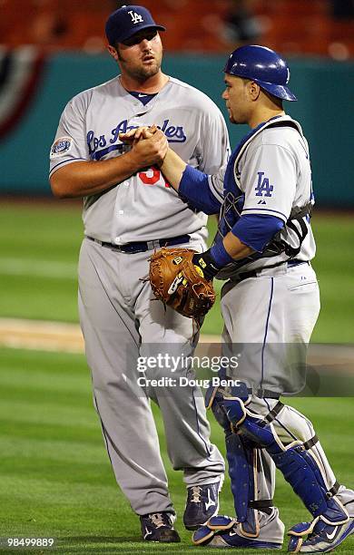 Relief pitcher Jonathan Broxton and catcher Russell Martin of the Los Angeles Dodgers celebrate after defeating the Florida Marlins during the...