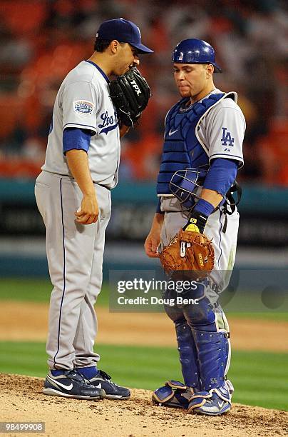 Relief pitcher Russ Ortiz and catcher Russell Martin of the Los Angeles Dodgers talk on the mound while taking on the Florida Marlins during the...