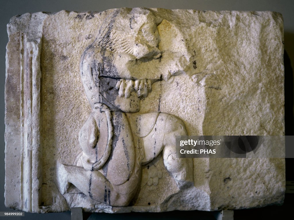 Relief of Heracles shooting arrow.