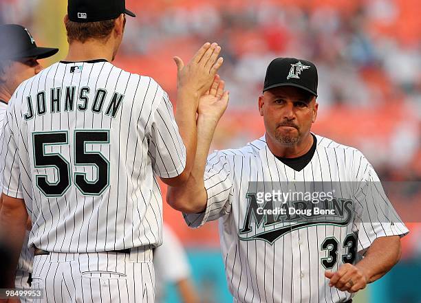 Fredi Gonzalez of the Florida Marlins is greeted by pitcher Josh Johnson before taking on the Los Angeles Dodgers in the Marlins home opening game at...