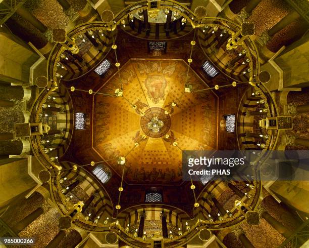 The Barbarossa chandelier under the dome of the Octagon. Palatine Chapel . Aachen Cathedral, Germany.