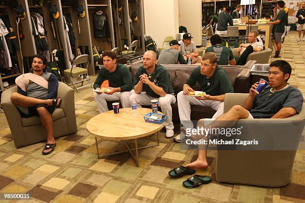 Eric Chavez, Craig Breslow, Chad Gaudin, Andrew Bailey and Kurt Suzuki of the Oakland Athletics watch TV in the clubhouse prior to the game against...