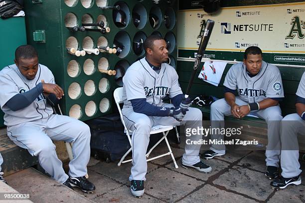 Ken Griffey Jr, Chone Figgins and Jose Lopez of the Seattle Mariners relaxing in the dugout prior to the game against the Oakland Athletics at the...