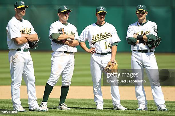 Kevin Kouzmanoff, Cliff Pennington, Mark Ellis and Daric Barton of the Oakland Athletics look on during a pitching change against the Seattle...
