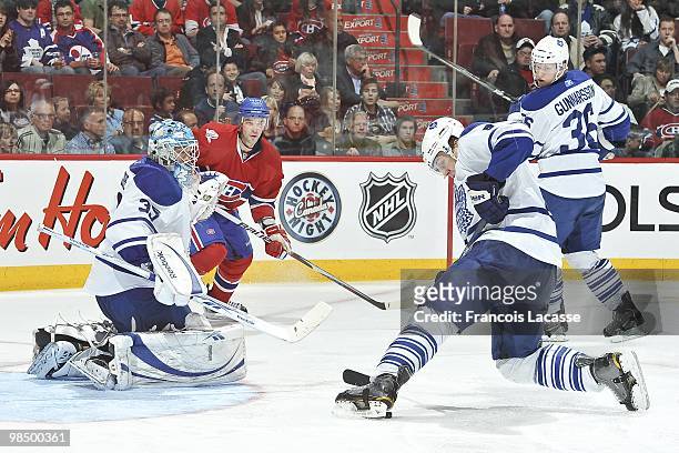 Nikolai Kulemin of the Toronto Maple Leafs blocks a shot of Benoit Pouliot of the Montreal Canadiens in front of Jean-Sebastien Giguere of the...
