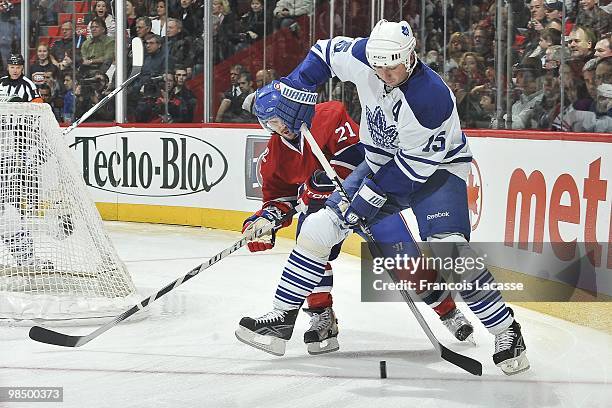 Tomas Kaberle of the Toronto Maple Leafs battles for the puck with Brian Gionta of Montreal Canadiens during the NHL game on April 10, 2010 at the...