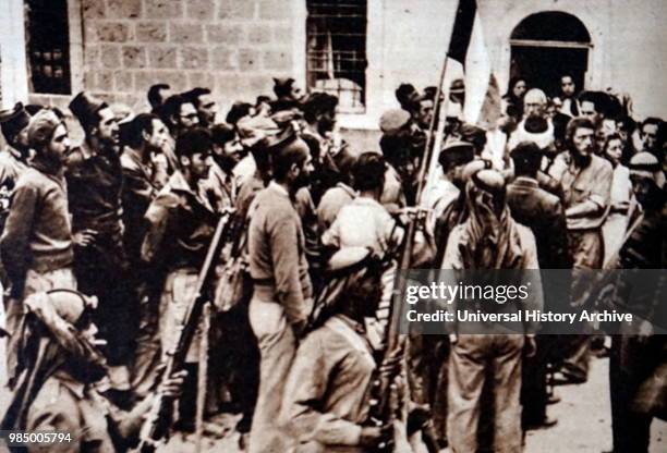 Photograph of Jewish Haganah troops being surrounded by Arab guards following the surrender of the Jewish Quarter in the Old City of Jerusalem. Dated...