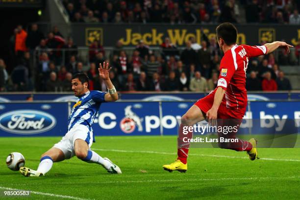 Zoran Tosic of Koeln scores the first goal past Anthar Yahia of Bochum during the Bundesliga match between 1. FC Koeln and VfL Bochum at...
