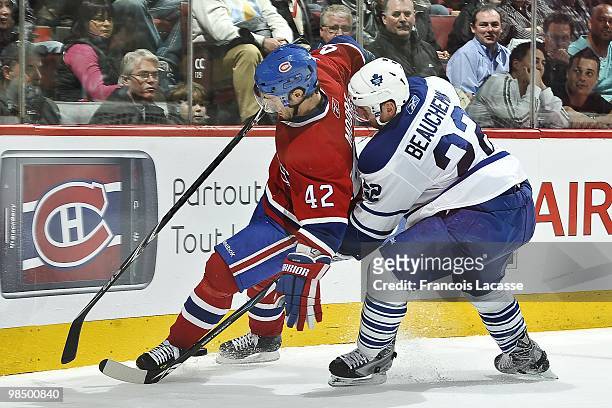 Dominic Moore of the Montreal Canadiens battles for the puck with Francois Beauchemin of the Toronto Maple Leafs during the NHL game on April 10,...