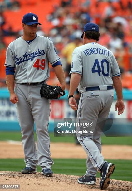 Starting pitcher Charlie Haeger of the Los Angeles Dodgers waits for pitching coach Rick Honeycutt to walk to the mound for a conversation while...