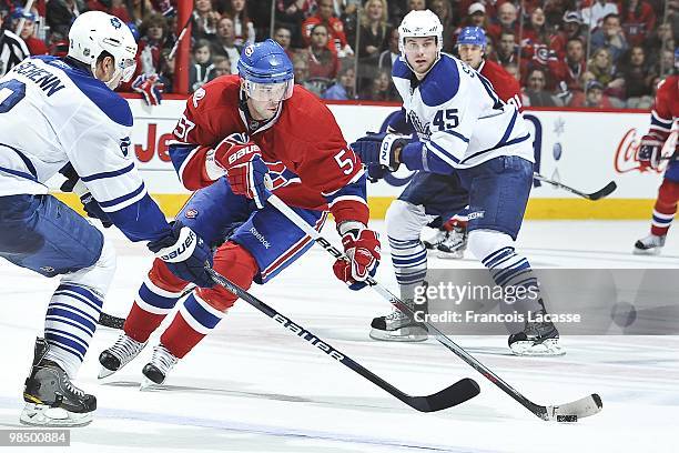 Benoit Pouliot of the Montreal Canadiens skates with the puck in front of Viktor Stalberg of the Toronto Maple Leafs during the NHL game on April 10,...