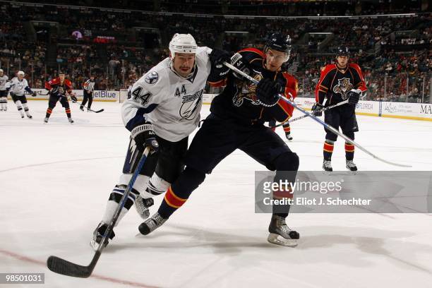 Keaton Ellerby of the Florida Panthers tangles with Nate Thompson of the Tampa Bay Lightning at the BankAtlantic Center on April 11, 2010 in Sunrise,...