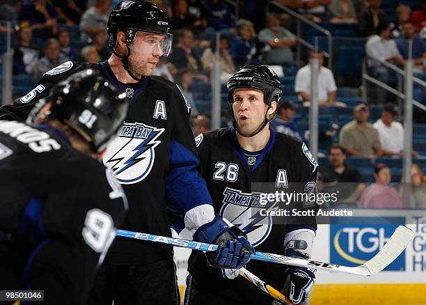 Martin St. Louis of the Tampa Bay Lightning talks to teammate Mattias Ohlund during a break in the action against the Ottawa Senators at the St. Pete...