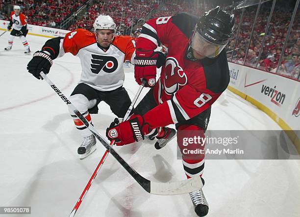 Kimmo Timonen of the Philadelphia Flyers and Dainius Zubrus of the New Jersey Devils battle for position in Game One of the Eastern Conference...