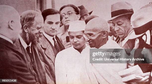 Photograph of Gandhi with reporters, taken at Marseilles in France 1931: Mohandas Gandhi was the preeminent leader of the Indian independence...