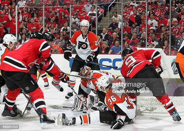 Brian Boucher of the Philadelphia Flyers makes save as players of the New Jersey Devils try for a rebound in Game One of the Eastern Conference...