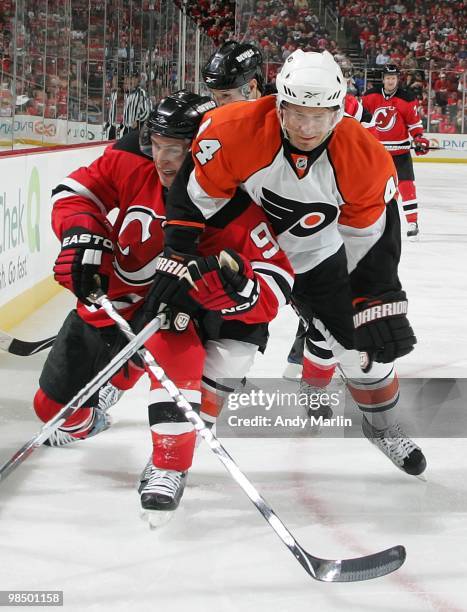 Kimmo Timonen of the Philadelphia Flyers and Zach Parise of the New Jersey Devils battle hard for position in Game One of the Eastern Conference...