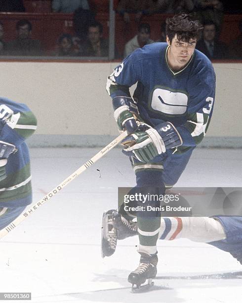 Pat Quinn of the Vancouver Canucks skates against the Montreal Canadiens in the 1970's at the Montreal Forum in Montreal, Quebec, Canada.