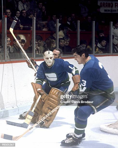 Pat Quinn of the Vancouver Canucks skates against the Montreal Canadiens in the 1970's at the Montreal Forum in Montreal, Quebec, Canada.
