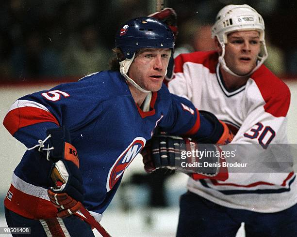 Denis Potvin of the New York Islanders skates against Richard Meagher of the Montreal Canadiens in the 1980's at the Montreal Forum in Montreal,...