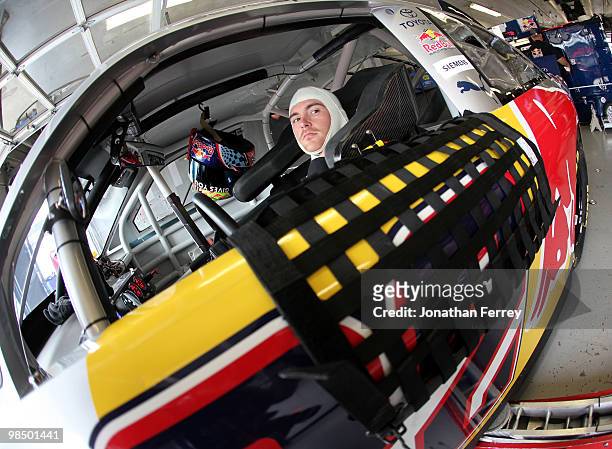 Scott Speed, driver of the Red Bull Toyota, sits in his car during practice for the NASCAR Sprint Cup Series Samsung Mobile 500 at Texas Motor...