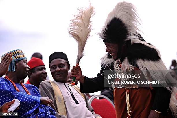 An elder man from the Kenyan Kikuyu tribe wears traditional ceremonial gowns as he greets several Nigerian Kings during a ceremony in the western...