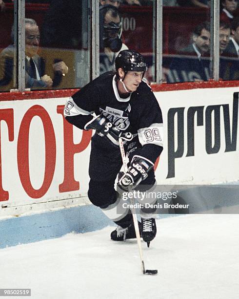Wayne Gretzky of the Los Angeles Kings skates with the puck against the Montreal Canadiens in the 1990's at the Montreal Forum in Montreal, Quebec,...
