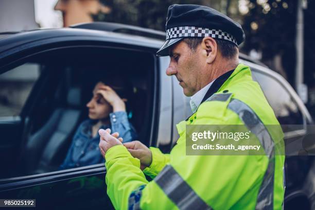 woman pulled over by traffic cop - traffic cop stock pictures, royalty-free photos & images